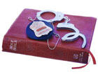 Bible, police badge and handcuffs